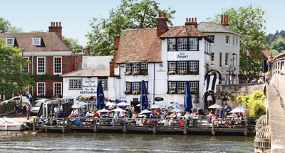 The Angle on The Bridge pub in Henley on Thames: the terrace on the rivers edge in front of the white pub building
